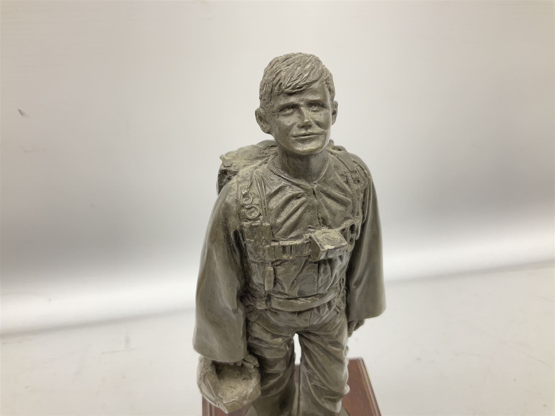 Presentation bronzed figure of a paratrooper by Peter Hicks mounted on a mahogany plinth with plaque inscribed ' Presented to Lieutenant General Sir Michael Gray KCB OBE President Army Parachute Association 1981-1987 An Outstanding Term of Leadership Friendship and Humour. Thank You All Ranks A.P.A.' H28cm; a brass Pegasus plaque H12cm; and small quantity of colour photographs and prints of military related paintings