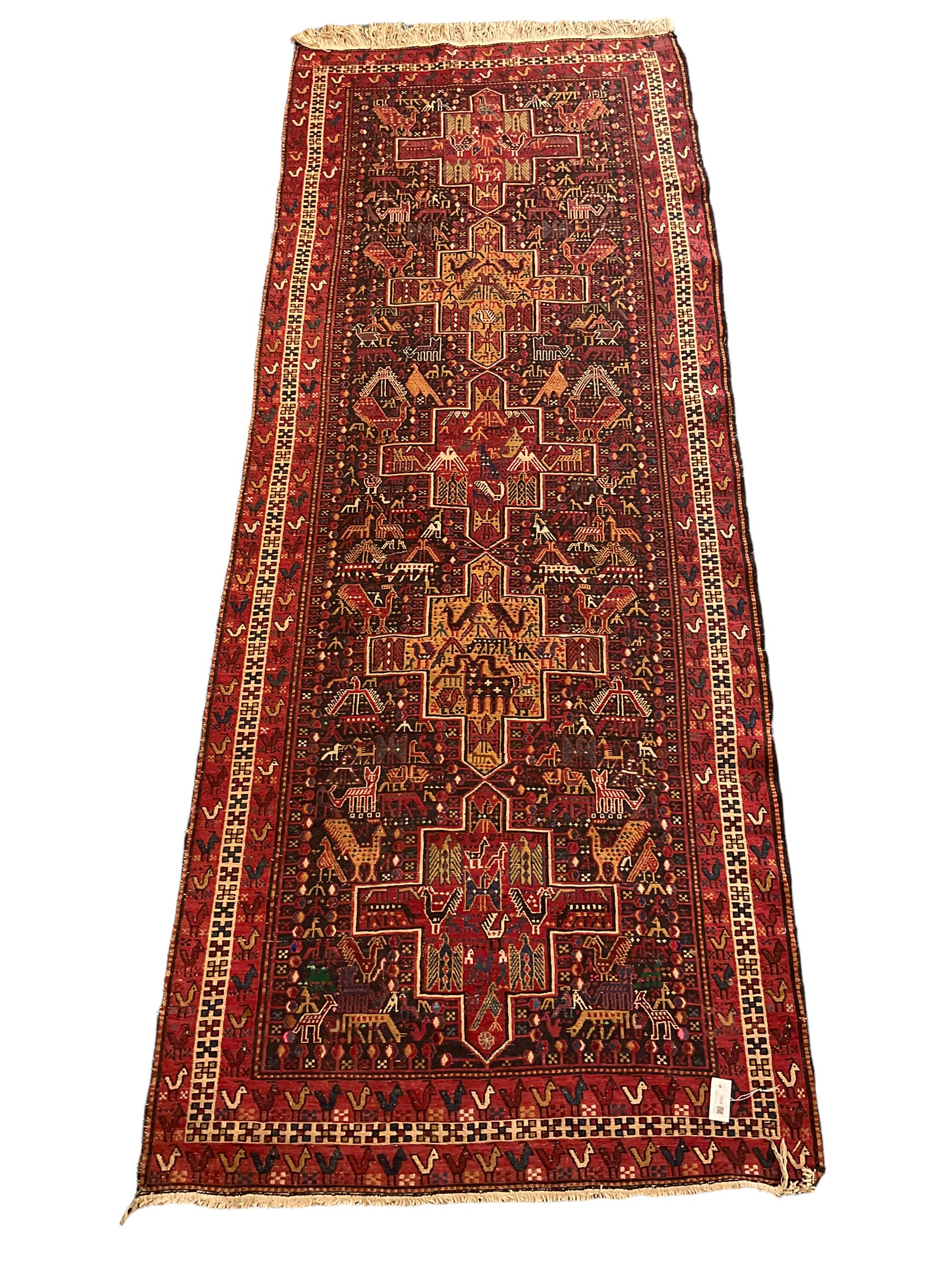North African flat-woven rug, decorated with small stylised animal and bird motifs, five geometric star medallions