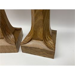 Mouseman - pair of tooled oak candlesticks, wrought iron sconce with drip tray over tapered octagonal column carved with mouse signature, terminating to stylised leaf carved square base, by the workshop of Robert Thompson, Kilburn
