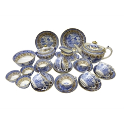 Early 19th century Miles Mason tea set, transfer printed in the Broseley Willow pattern with gilt highlights comprising teapot, sucrier, slop bowl, eight tea cups and saucers, three tea bowls, two shallow dishes, milk jug and saucer & three spare tea cups (29)  