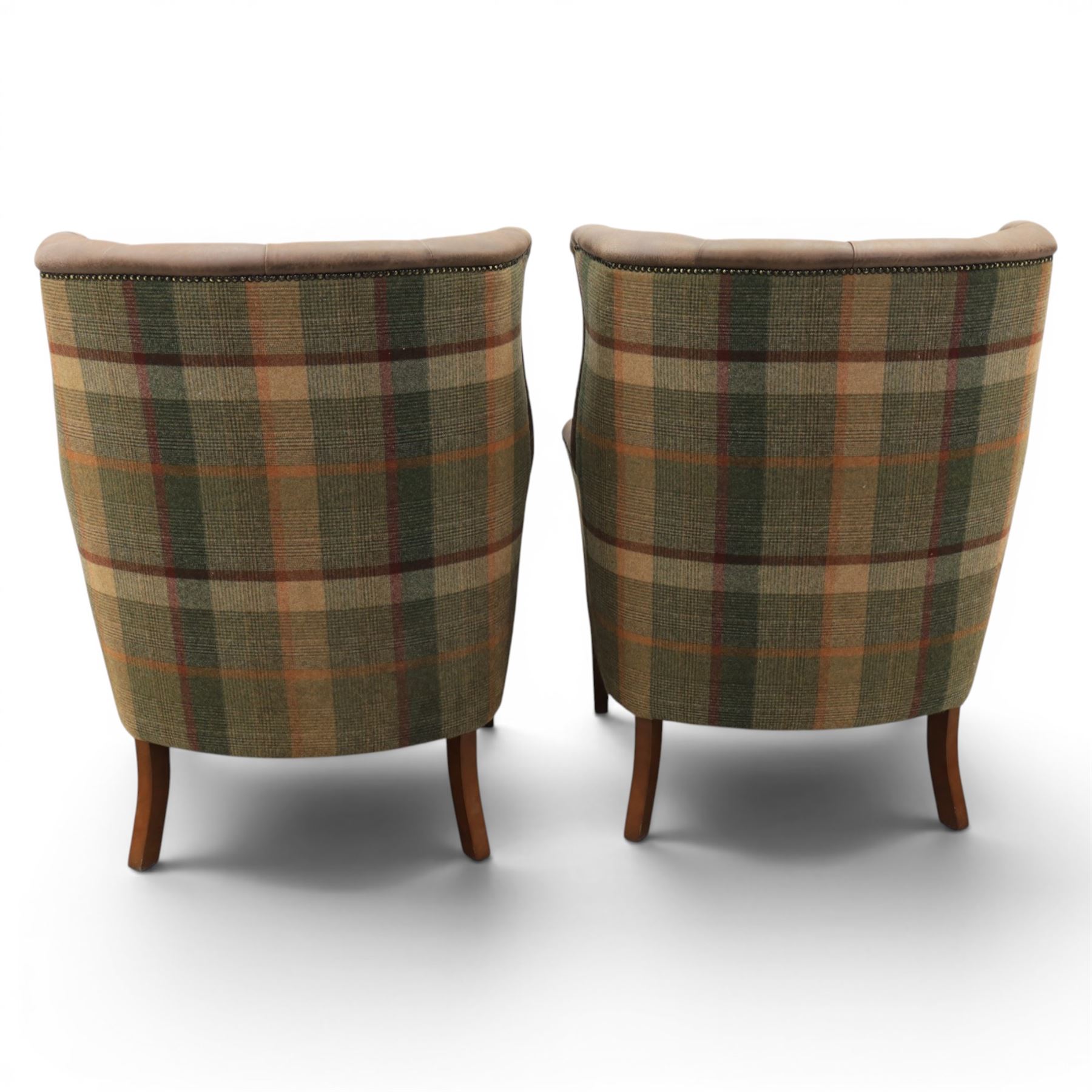 Pair of Georgian design wingback armchairs upholstered in brown leather and tartan tweed fabric, button back and scrolled arms with brass studded trim, square tapered supports
