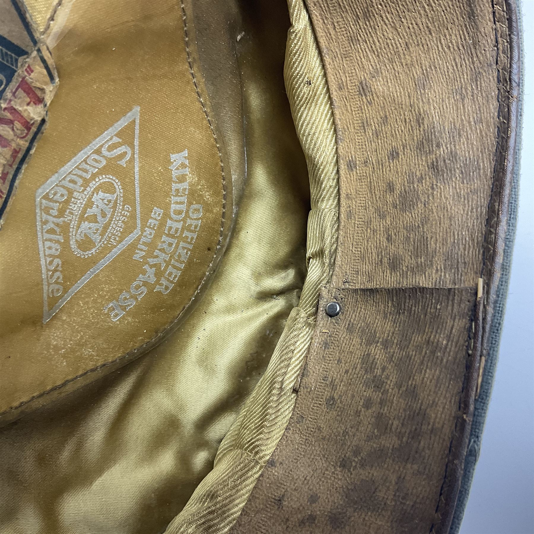WW2 German Infantry Officer's visor cap with cloth insignia; labelled and stamped Offizier Kleiderkasse Berlin and Erel Stirnschutz