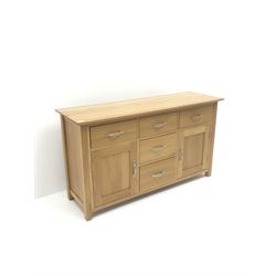 Light oak sideboard, five drawers and two cupboards, stile supports