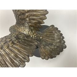 Bronze eagle, modelled in a standing position with wings spread, raised on a black veined marble circular plinth base, H29cm