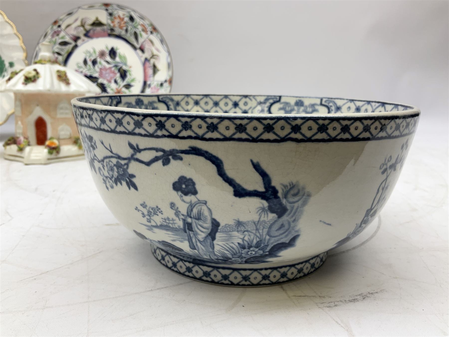 Mid 18th century Chelsea plate with gold anchor mark beneath, decorated with green floral sprays upon plain ground, the moulded cavetto shaped border with gilt rim, (A/F), D22cm, together with early 20th century Adams Tunstall Tokio pearlware slop bowl, Spode plate decorated in the Imari type pallette, with impressed and printed marks beneath, 19th century Indian Tree pattern breakfast cup and saucer, small polychrome enamelled vase and cover in the style of Samson of Paris, with marks beneath, and a pastille burner