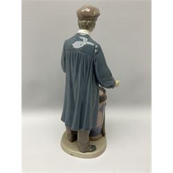 Lladro figure, 'Predicting the Future', modelled as a male donning hat with pipe standing above a barrel containing a dial with its lid removed, no. 5191, printed Daisa marks beneath, H29.5cm