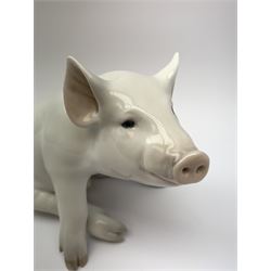 A Royal Copenhagen model of a seated pig, model no 414, H16cm