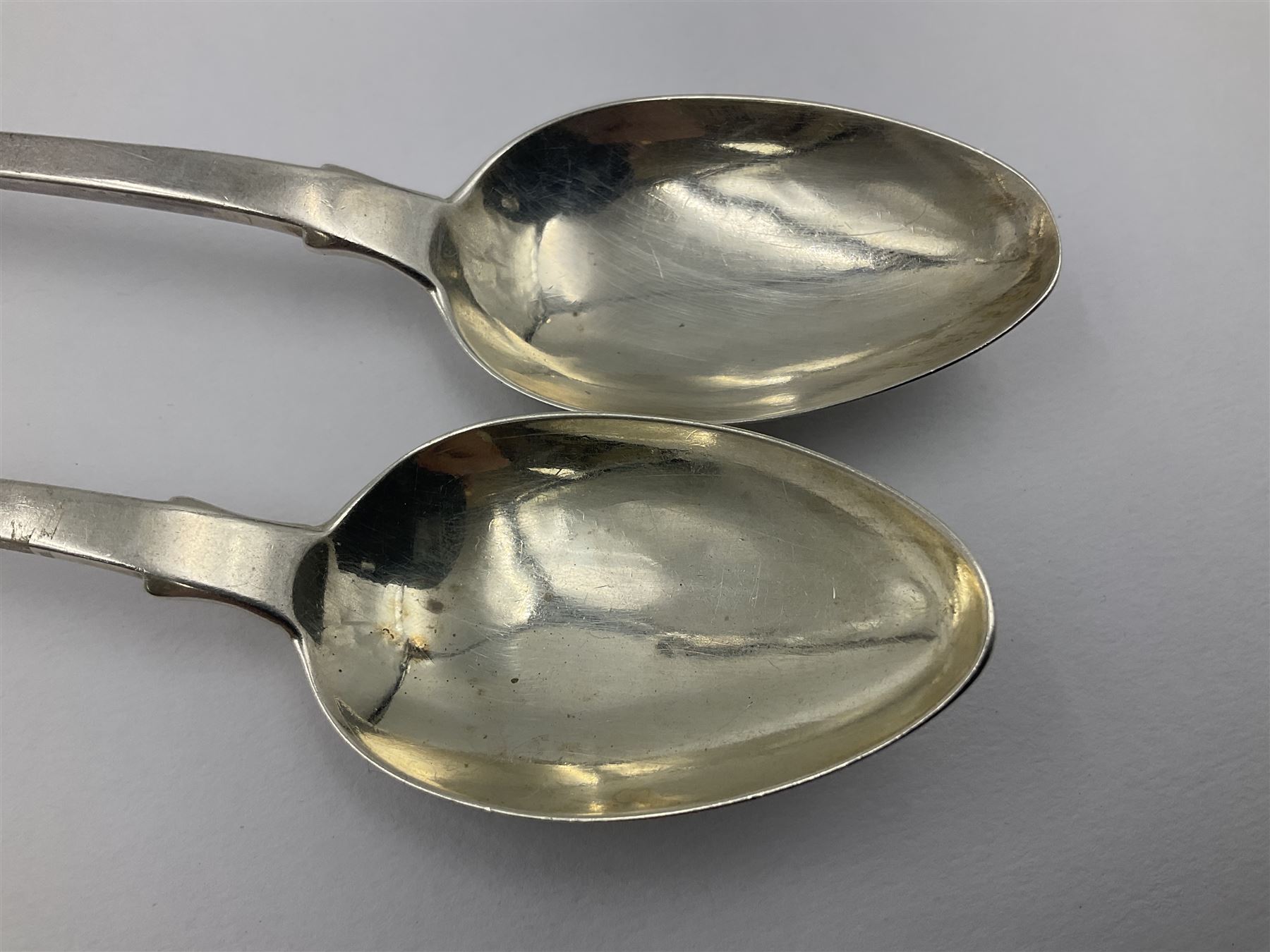 Pair of George III York silver Fiddle pattern dessert spoons, each engraved with a rampant lion crest, hallmarked James Barber & William North, York 1789