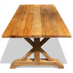Pine country x-framed dining table, a rustic plank top raised on two x-framed supports