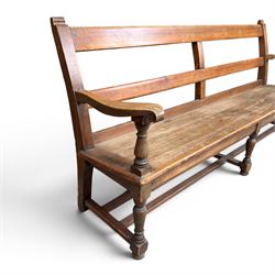 Early 20th century pine and oak bench seat, stained pine rail back frame with shaped oak arms