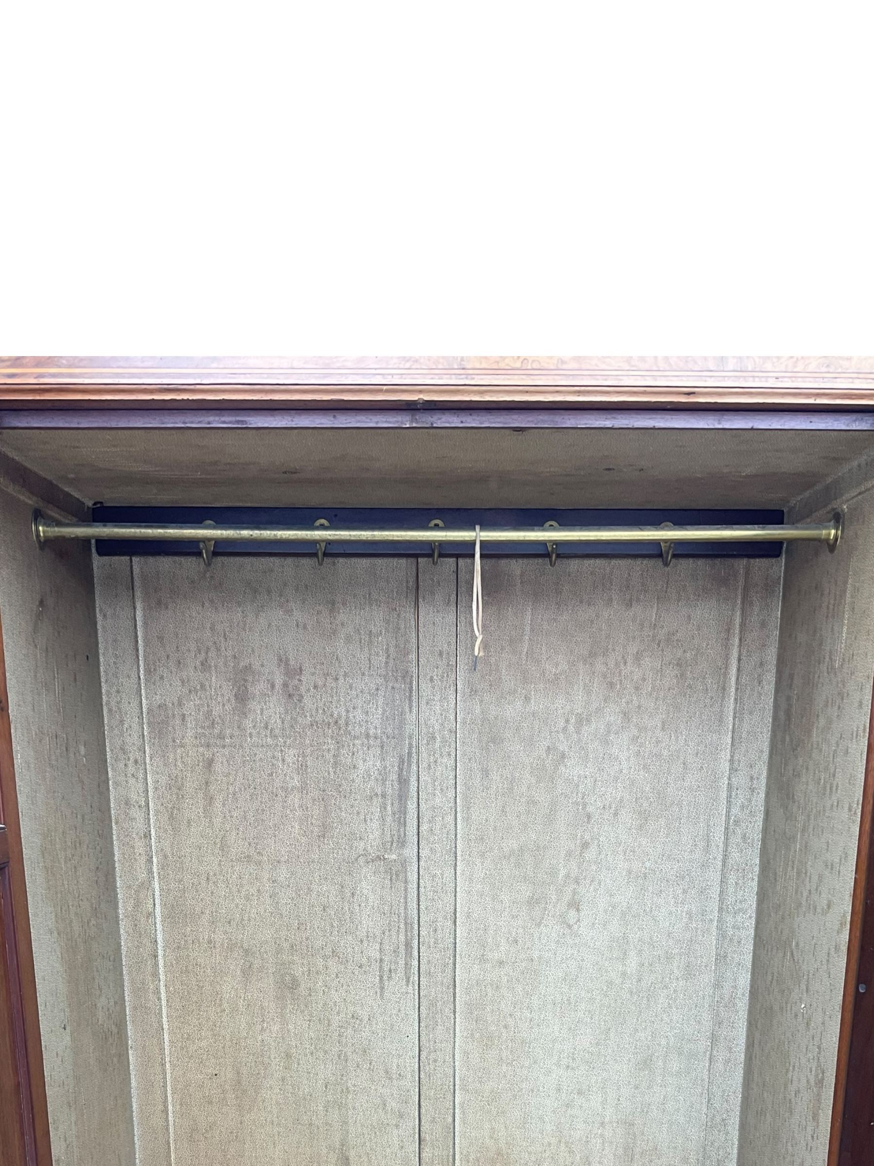 Late Victorian walnut triple combination wardrobe, projecting moulded and dentil cornice, central shaped bevelled mirror glazed door, cartouche and curled leaf carved panels over figured walnut veneered panels, fitted with drawer to base, on bracket feet