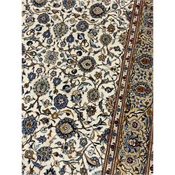 Fine Persian Kashan rug, ivory ground and decorated with interlacing branch and stylised plant motifs, scrolling guarded border decorated with small flower heads