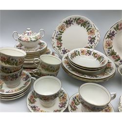 Paragon Country Lane pattern tea and dinner wares, comprising three dinner plates, six salad plates, nine side plates, three bowls, three smaller bowls, oval bowl, serving platter, sandwich plate, cake plate, seven teacups, two mugs, six saucers, twin handled sucrier and cover, open sucrier, and milk jug, together with Colclough teawares, including a cake stand. 