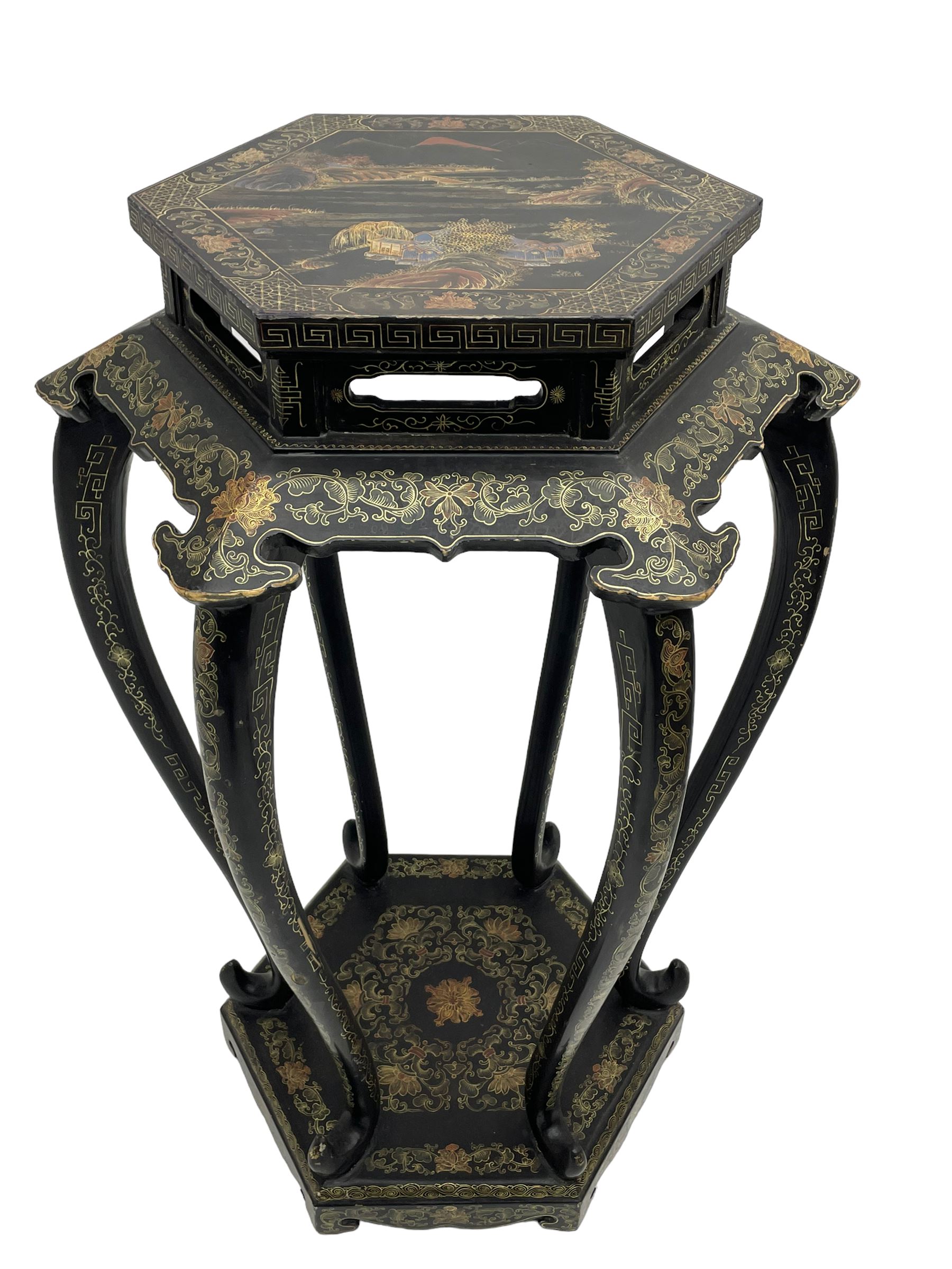 Chinese black lacquer jardinière stand, the hexagonal top painted with traditional landscape scenes within a gilt strung border, the pierced frieze with trailing foliate decoration and geometric patterns, supported on six cabriole supports united by a raised hexagonal base