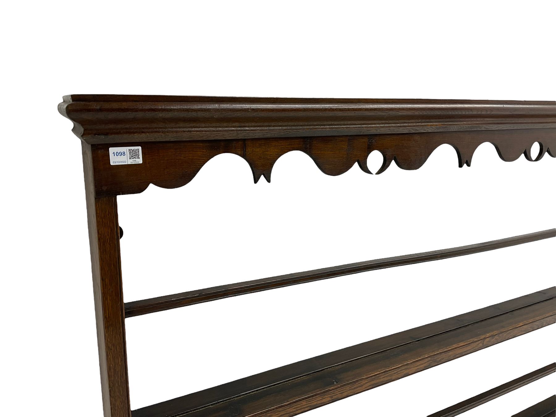 20th century oak wall hanging plate rack, shaped fretwork frieze over three tiers