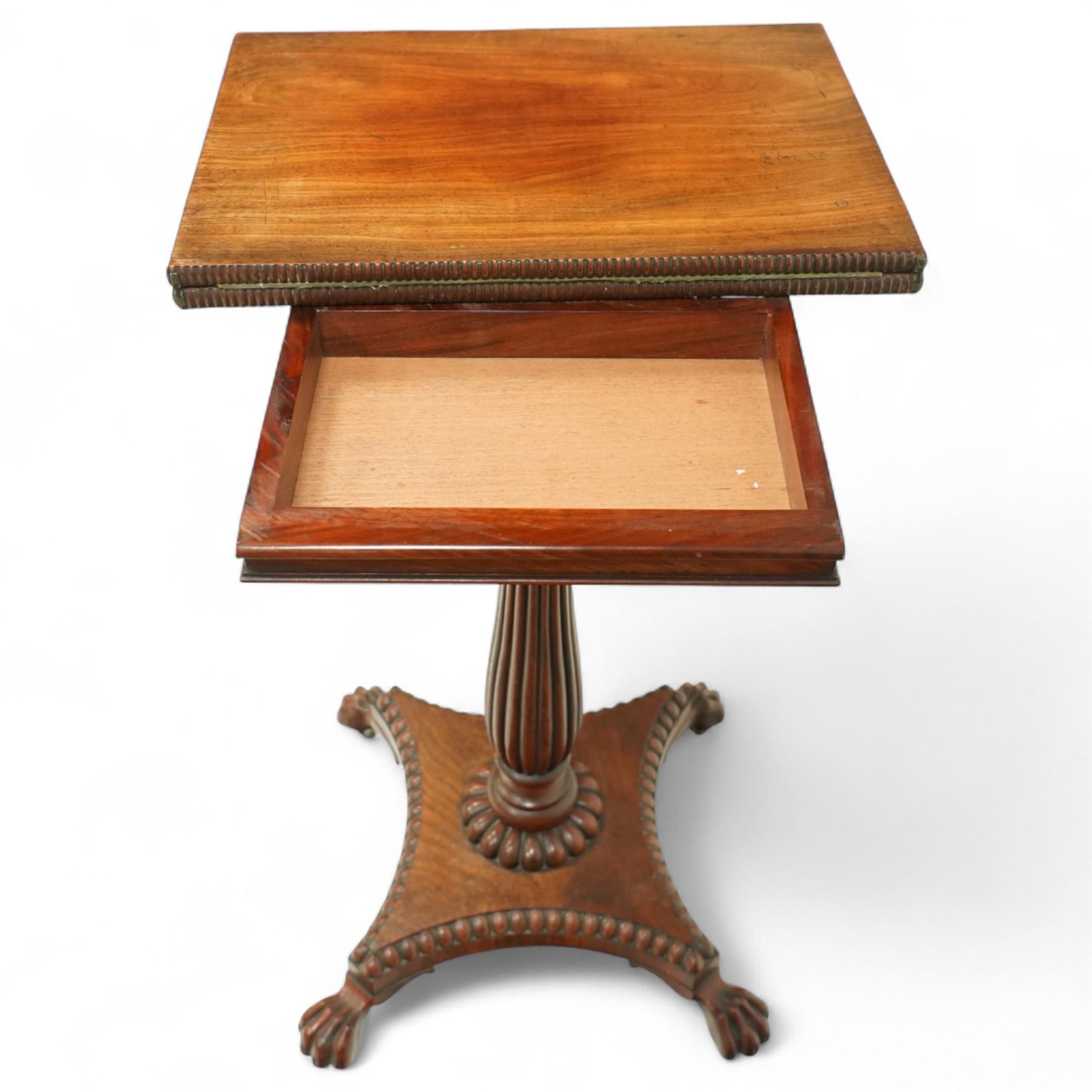 William IV mahogany folding card table of unusually small proportions, rectangular swivel top with gadrooned edge, raised on a slender tapered reeded column over quatreform base with gadrooned border, terminating in carved lion paws feet