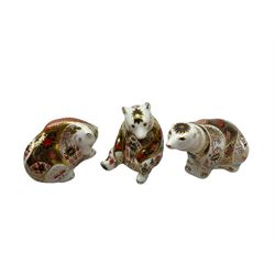 Three Royal Crown Derby paperweights, comprising, mountain bear with gold stopper, honey bear with silver stopper and polar bear with silver stopper
