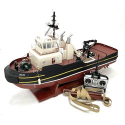 24-Volt radio controlled model of the American tug boat 'Jo-Jo' with full range of deck fittings, transmitter, remote control, receivers and two launching straps, displayed on wooden stand L103cm