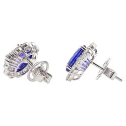Pair of 18ct white gold oval tanzanite, baguette and round brilliant cut diamond cluster stud earrings, total tanzanite weight 7.37 carat, total diamond weight 2.01 carat, with World Gemological Report
