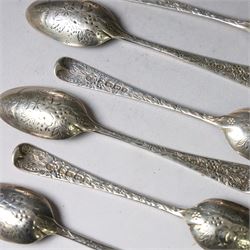 Eleven Victorian silver teaspoons, profusely engraved with floral decoration throughout with family crest to terminal, hallmarked Elkington & Co, Birmingham 1875