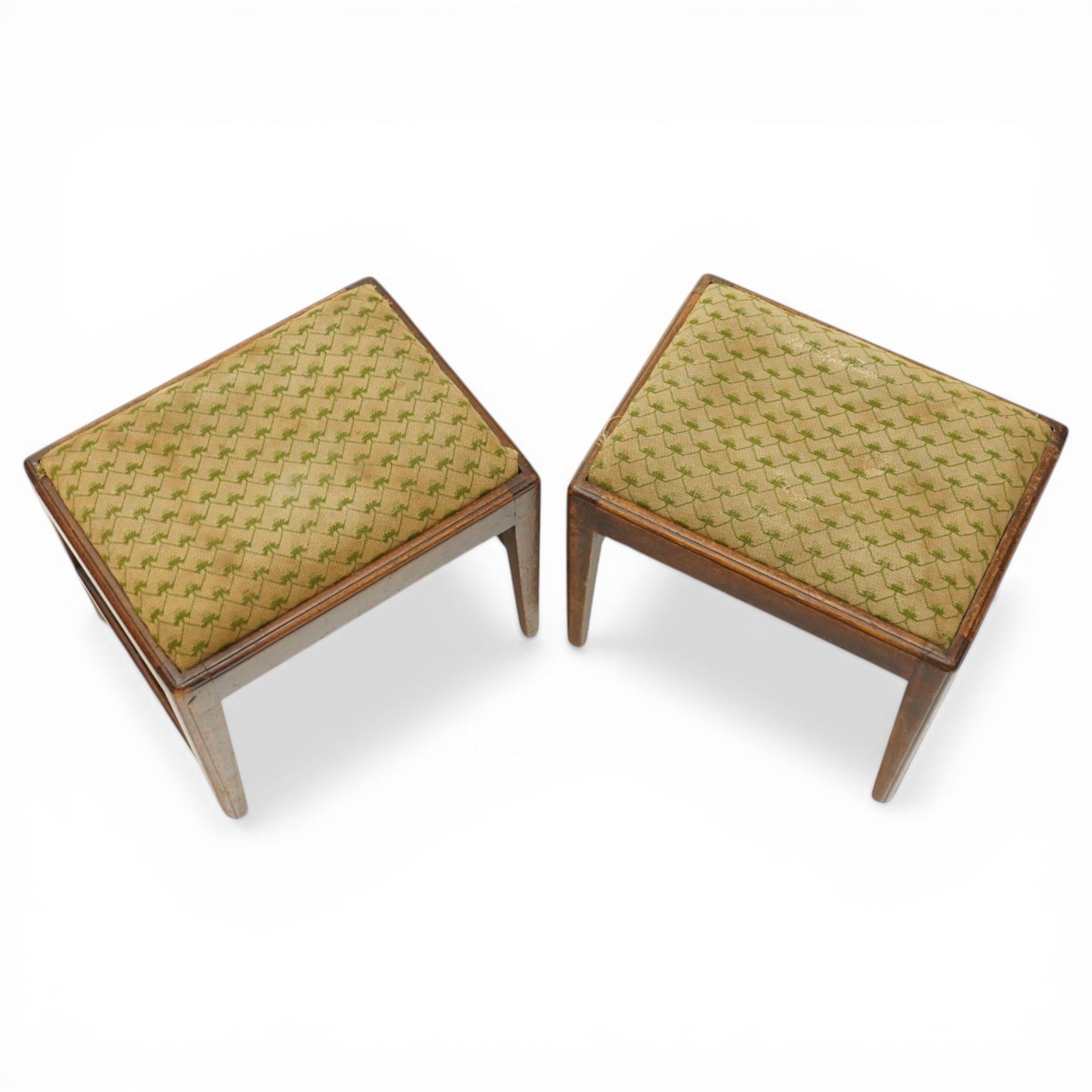 Pair of George III mahogany framed coaching stools, the drop-in seats upholstered in green and beige needlepoint fabric, raised on moulded and chamfered square tapering supports united by H-stretcher