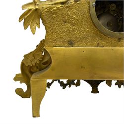 French - late 19th century 8-day gilt spelter mantle clock retailed by J Vassalli of Scarborough c1890, sculptured with an oriental 16th century representation a Mughal warrior slaying a leopard, raised on a profusely  decorated base with scroll work and splayed feet, white enamel dial with Roman numerals, minute track and steel hands, Parisian twin train countwheel striking movement, striking the hours and half-hours on a bell. With pendulum & Key.  