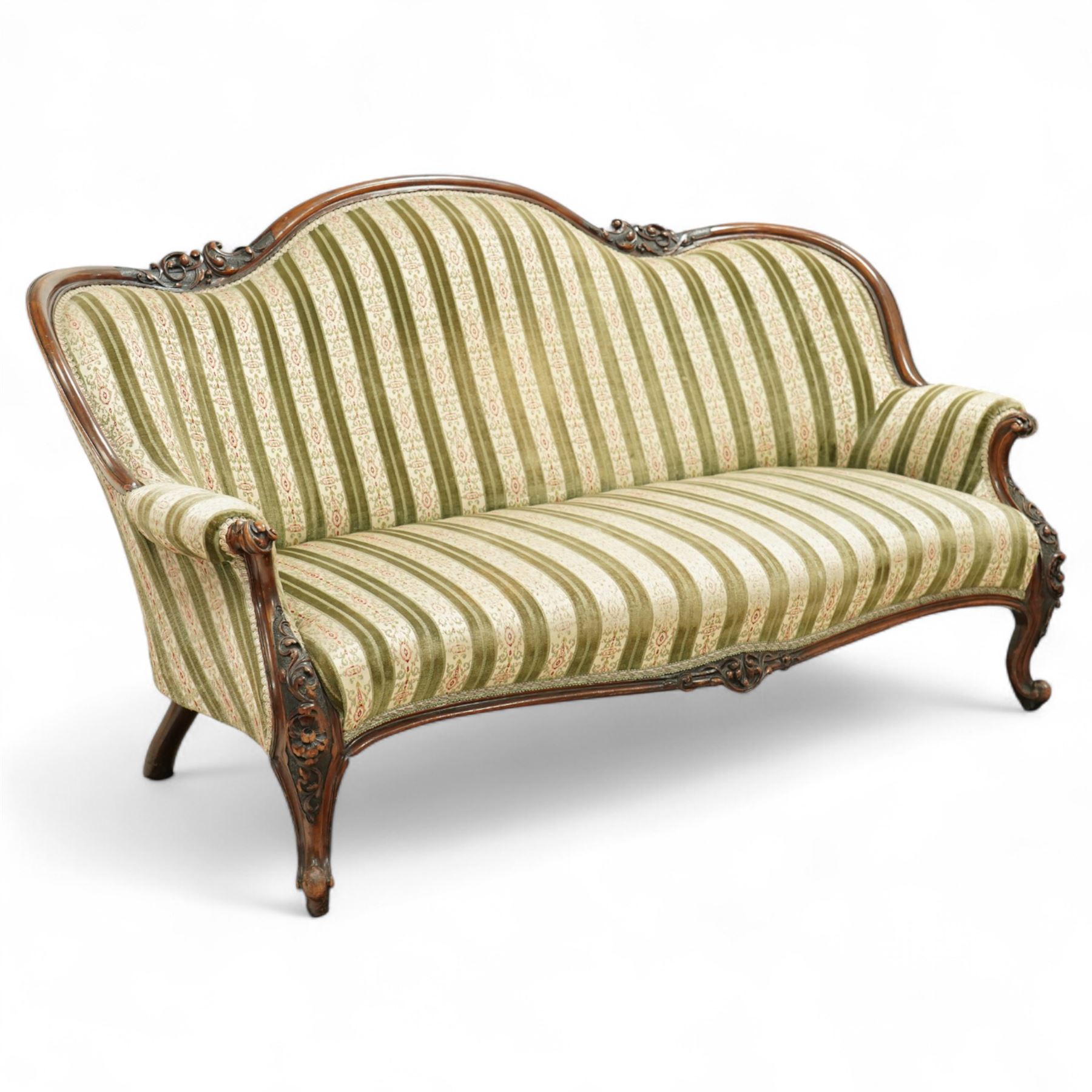 Victorian walnut framed salon sofa, the shaped back and scroll arms with carved floral detail, upholstered in green and cream striped fabric, raised on scrolled cabriole legs 