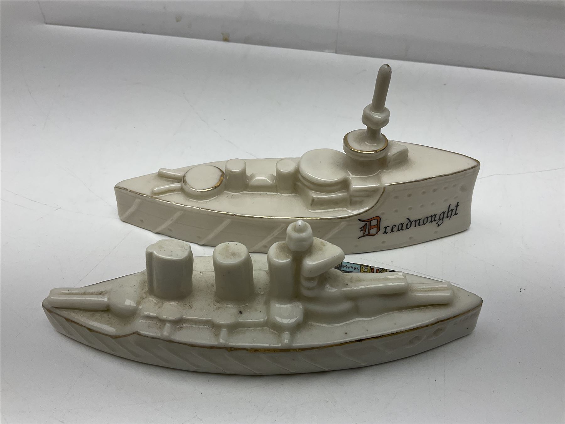 Ten WW1 crested china military models comprising submarine, four ships including Lusitania, four Zeppelins/balloons and an aircraft; various makers including Arcadian China, Swan China, Carlton China, Waterfall, Grafton China etc; various crests including Saint Neots, Great Yarmouth, Tewksbury, Swanage, Simons Town, Hull etc (10)