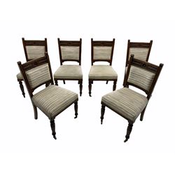 Set of six Edwardian carved oak salon chairs, the cresting rail carved with foliate and flower heads