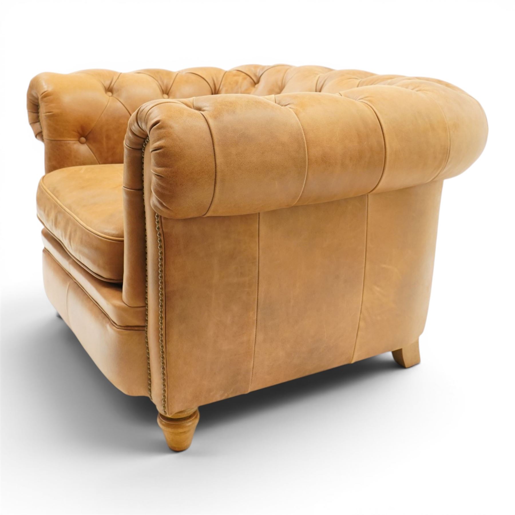Alexander James - Chesterfield tan armchair, button backed with scrolled arms, brass studded trim raised on light wood turned feet
