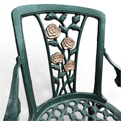 Cast aluminium oval garden table and set of four armchairs with pierced rose design back splats