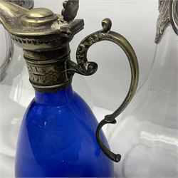 Silver plate mounted blue glass claret jug of ovid form, with C scroll handle, together with two other silver plate mounted claret jug