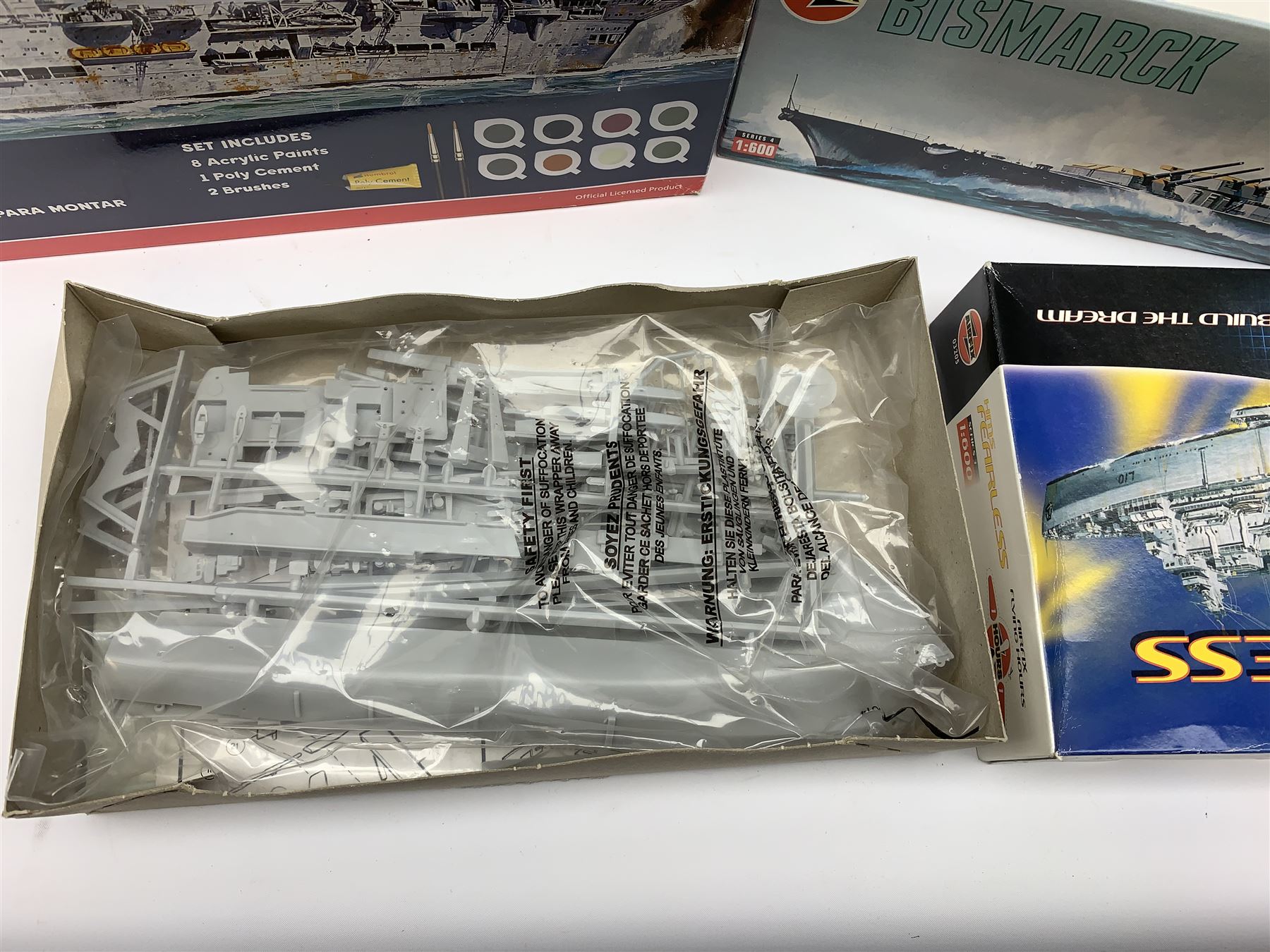 Ten plastic model kits of ships by Airfix, Revell, Dragon and Skywave, predominantly 1/600th scale including R.M.S. Titanic, HMS Invincible, two x HMS Ark Royal, HMS Fearless, HMS Hood, HMS Belfast, Bismarck etc; all boxed, most in factory sealed transparent packaging (10)