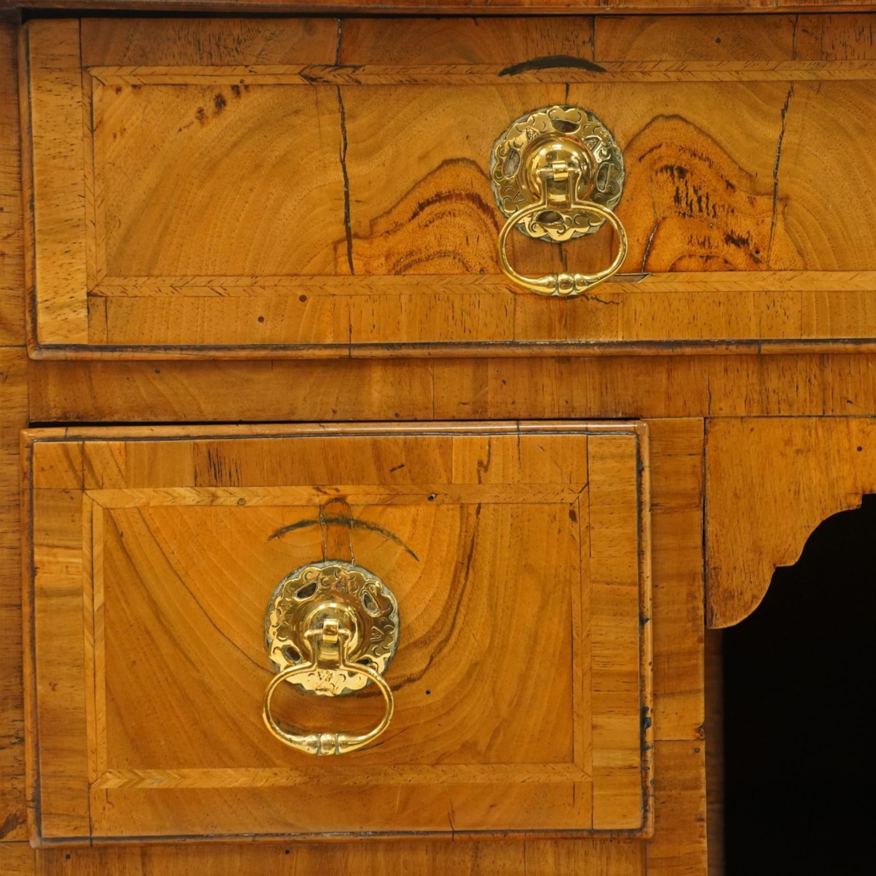 George III figured and burr walnut kneehole desk, the shaped rectangular top with feather and crossbanding surrounded by a moulded edge, fitted with single frieze drawer over three graduating drawers to each side, flanking a central recessed cupboard, lower moulded edge on bracket feet
Provenance: Kirkham Hall