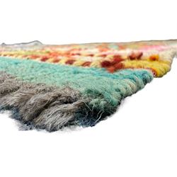 Tibetan-design handwoven rug, deep red field with three central medallions in yellow and blue, traditional yellow key border, white fringes on both ends