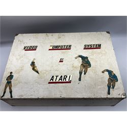 Atari 2600 'Woody' console with various joysticks and controllers etc, and a quantity of game cassettes to include 'Outlaw', 'Air Sea Seattle' and 'Codebreaker' etc housed in white painted wood case