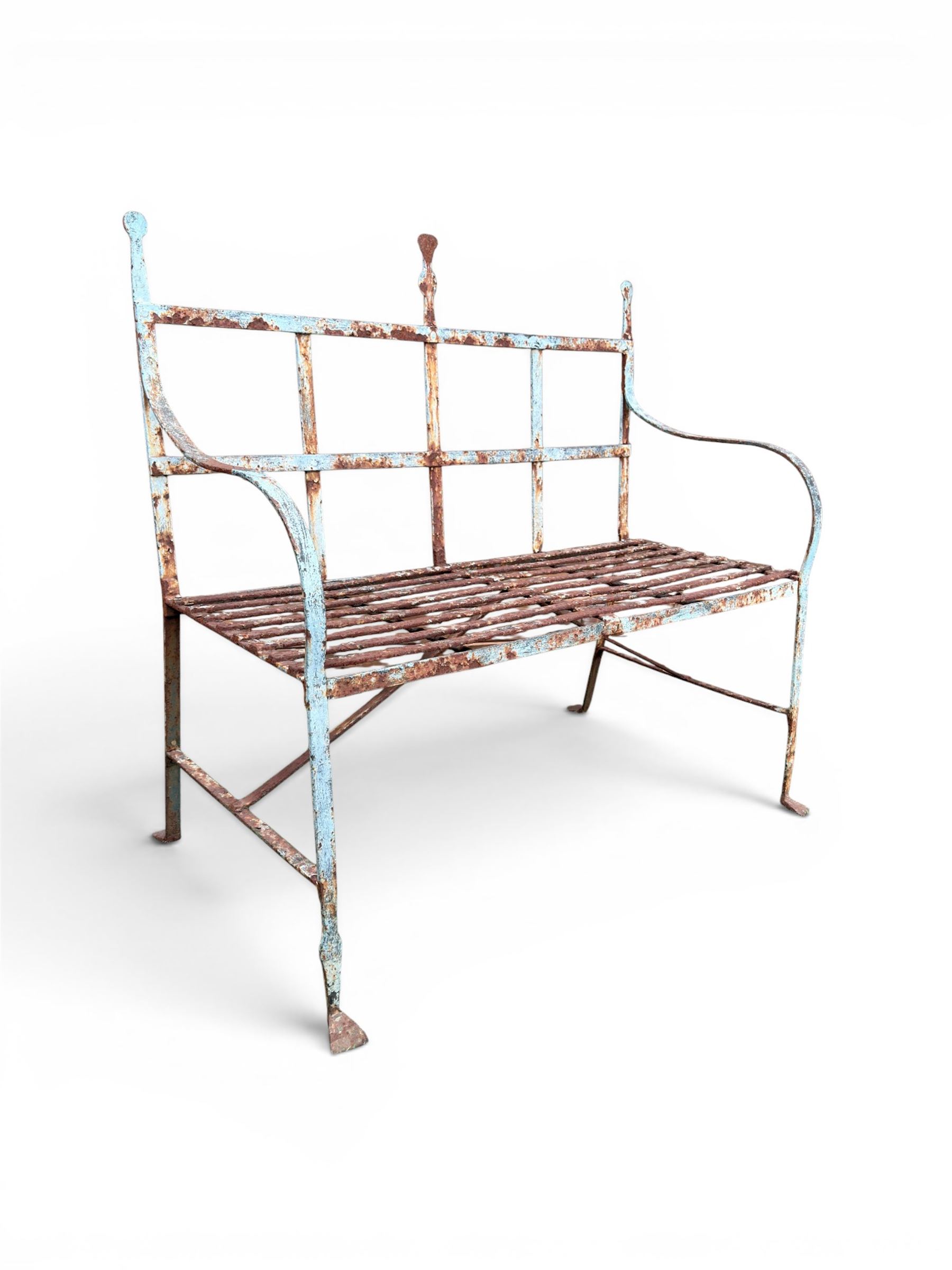 Regency period wrought iron strapwork garden bench, cresting rail with central Scottish thistle motif and flanking pediments, in distressed blue painted finish