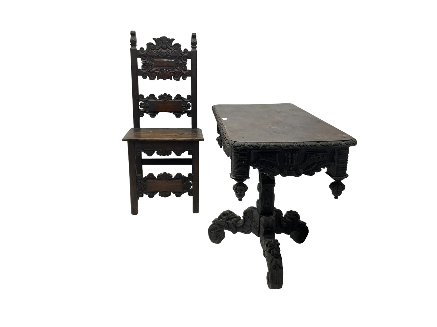 Late 19th century Gothic revival carved oak pedestal table, rectangular top with carved edges, apron carved with trailing foliate and scrolled decoration, heavily detailed column with scrolling decoration and floral carvings, the tripod base with cabriole supports carved with flowerheads (93cm x 53cm x 75cm; Late 19th century carved oak hall chair, panelled back rails with extending scroll decoration (51cm x 40cm x 116cm)