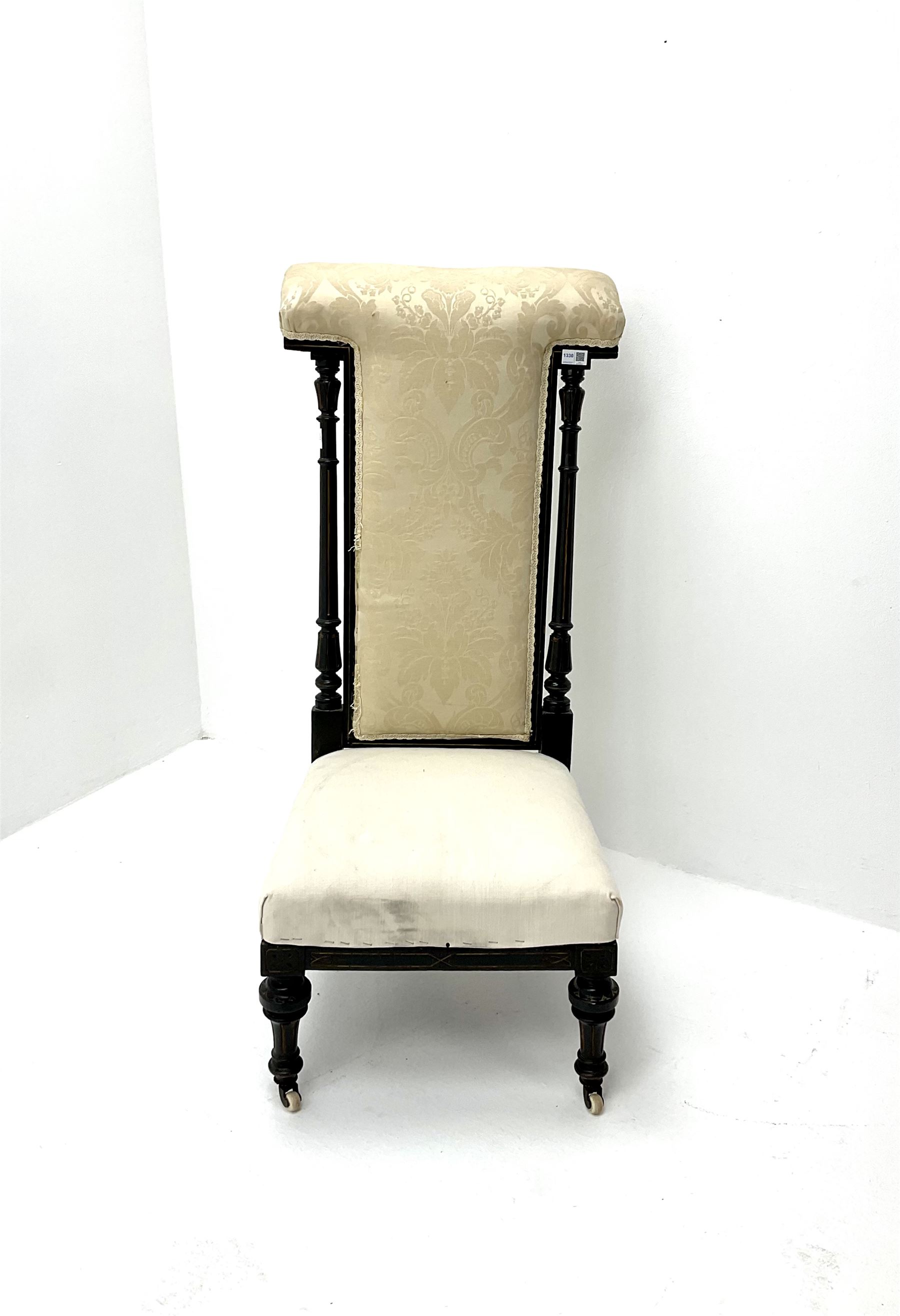 Victorian ebonised prie dieu chair upholstered in an ivory ground fabric, turned reeded and tapering supports