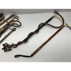 Collection of hunting crops and riding whips, including horn handle examples with silver cuffs