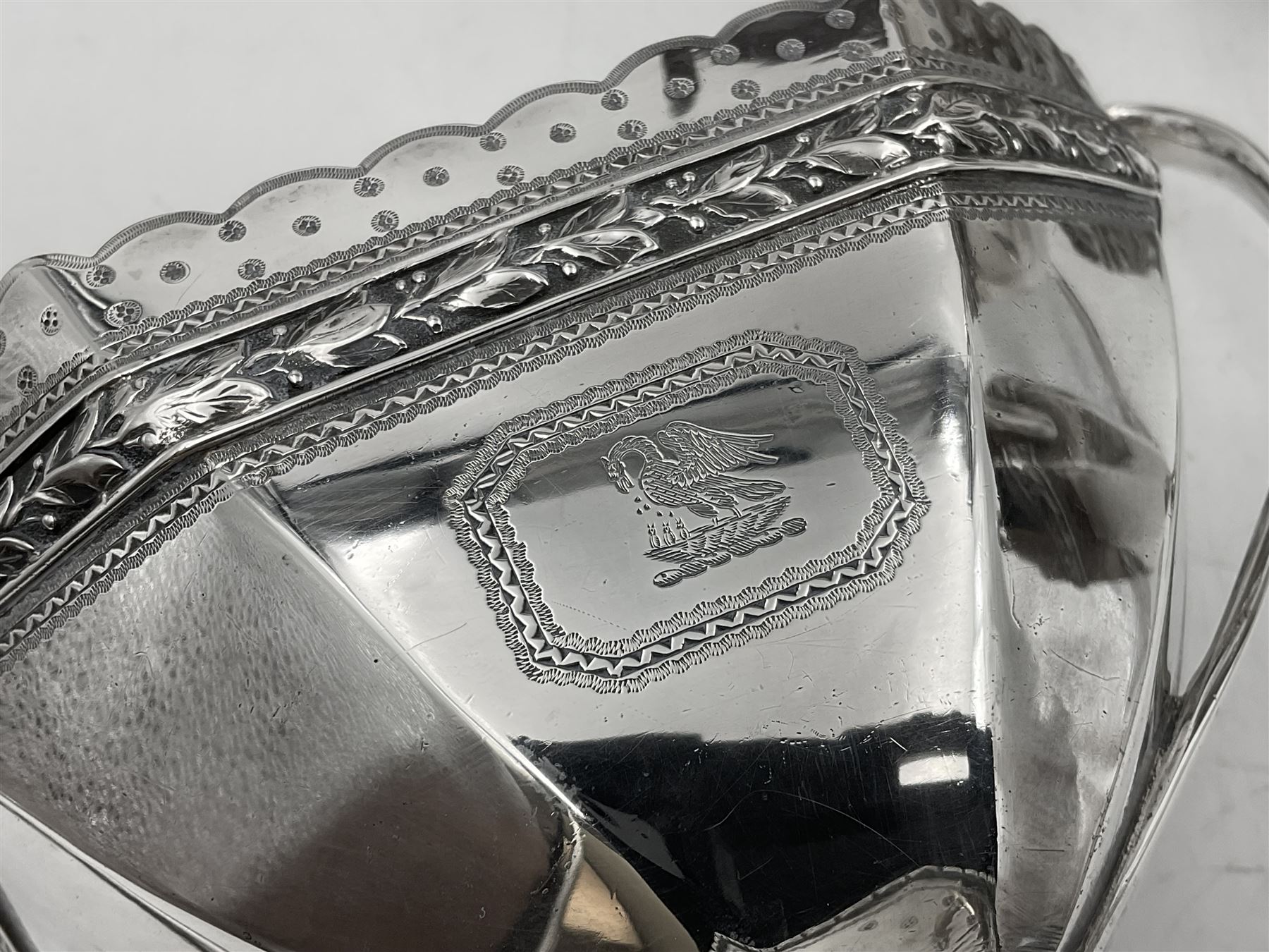 Victorian silver four piece tea service, comprising teapot, teapot stand, twin handled open sucrier and milk jug, each of octagonal form with foliate bud border and engraved decoration including crest to canted panels, and vacant panels, the teapot with ivory finial to the hinged cover and later wooden handle, hallmarked Edward Barnard & Sons Ltd, London1896, teapot including finial H15cm, milk jug including handle H16cm, teapot stand W11.5cm

This item has been registered for sale under Section 10 of the APHA Ivory Act