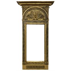 19th century Swedish Neo-Classical pier mirror, the projecting moulded cornice over arched frieze decorated with dolphins and scrolled foliate decoration, the frame decorated with flower head motifs with extending foliage, paper label to the reverse inscribed ‘Tillverkad uti L.M. Thims Spegel Fabrik vid Stortorget Stockholm (Made in L.M. Thim's Mirror Factory at Stortorget Stockholm)’