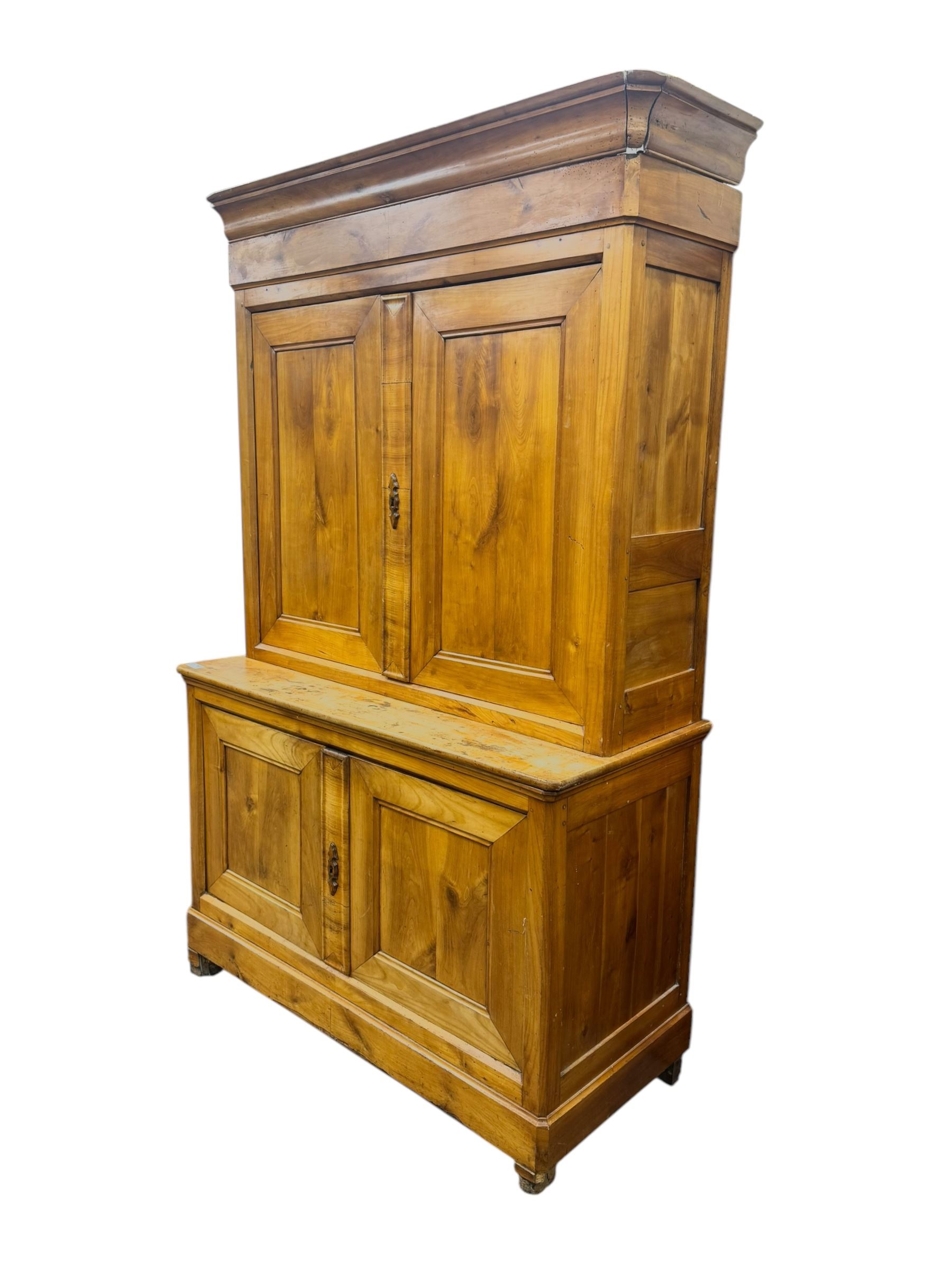 19th century French walnut dresser, the moulded cornice over two-panelled cupboard doors, enclosing two shelves and one small
drawer, on a base of two further cupboards
