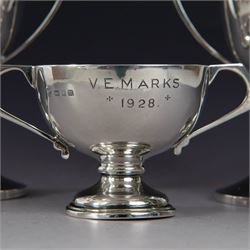 Pair of 1930s silver trophies, with angular handles and presentation engravings to body, hallmarked William Hair Haseler, Birmingham 1938, together with a similar smaller example, hallmarked Charles Boyton & Son Ltd,  London 1927, tallest H13cm