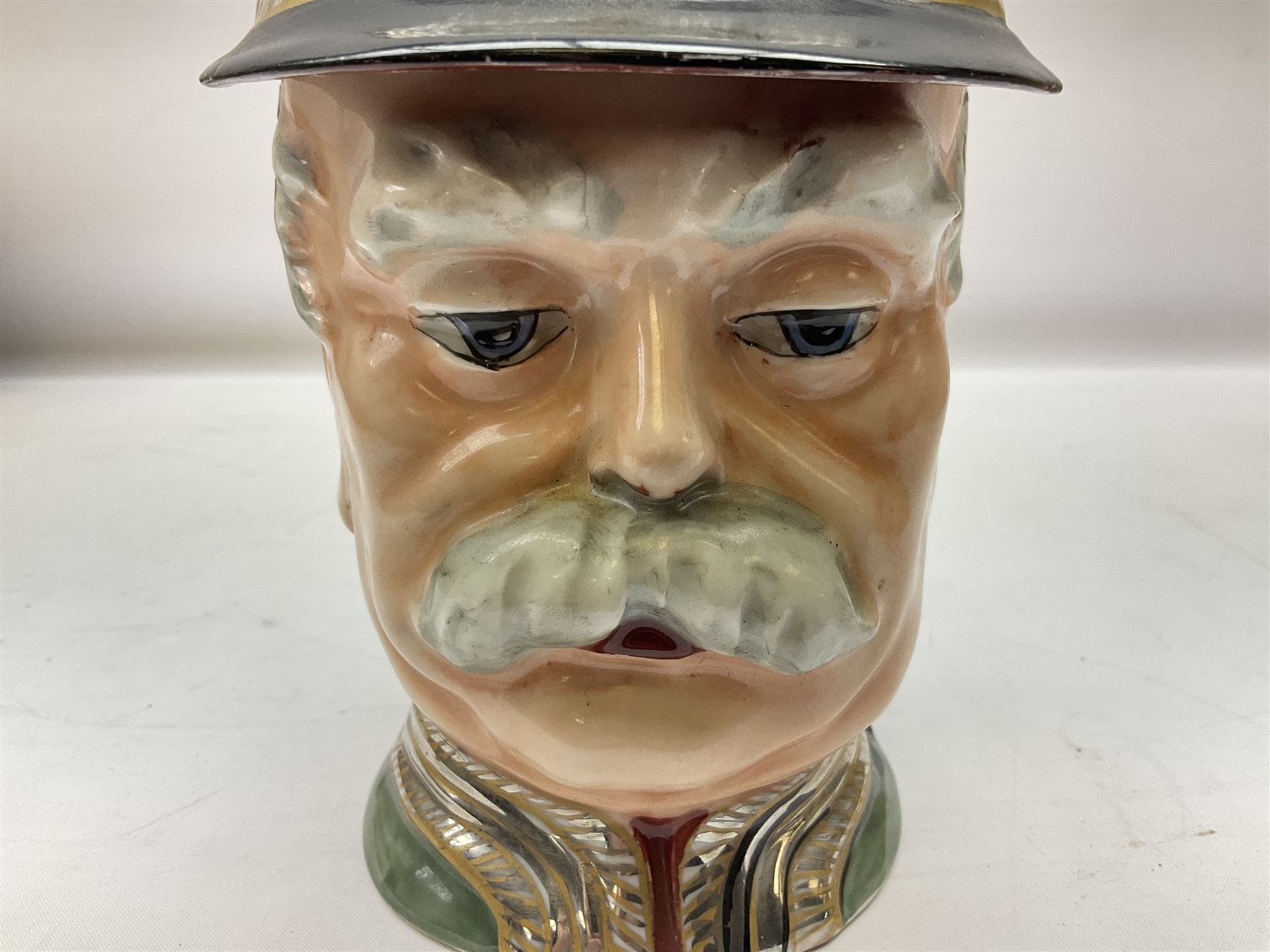 Otto Von Bismarck figural 0.5l stein, his black pickelhaube helmet with chrome spike serving as the lid, in green uniform and gilt detail throughout, pewter thumb hinge, with blue hash Musterschutz type mark, H18cm