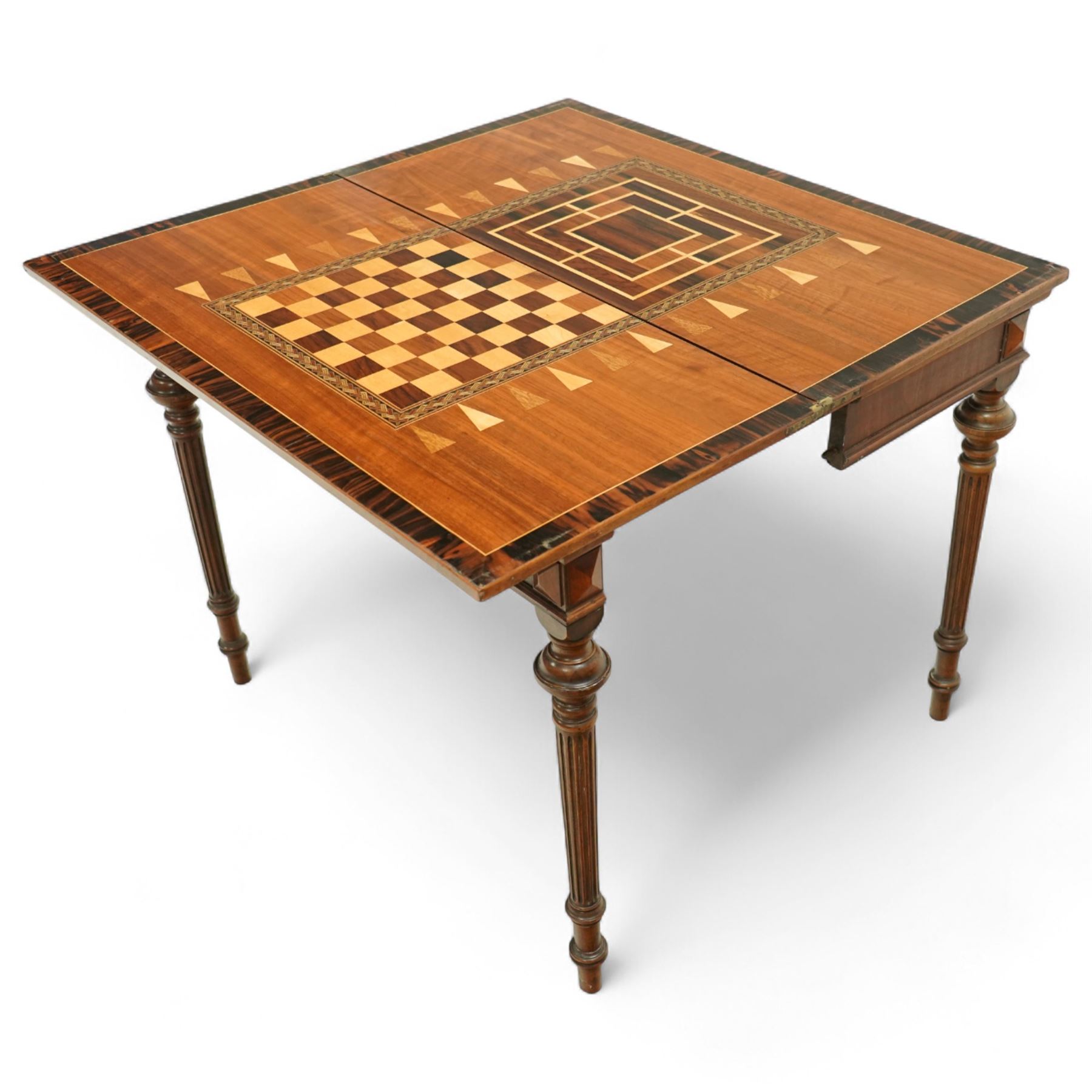 19th century mahogany fold-over card table, the crossbanded rectangular top opening to reveal an inlaid games centre with chessboard and backgammon designs, raised on turned and reeded legs with extending rear supports