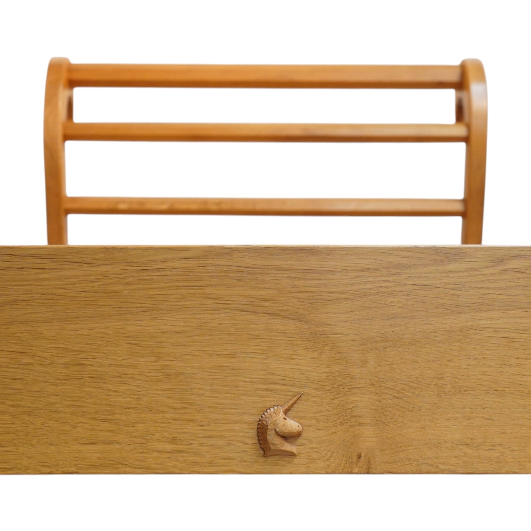 Unicornman - pair of craftsman-made oak single beds, of sleigh shape with scrolled head and foot-boards with octagonal stretchers, slatted base, raised on inward-splayed squared supports, applied with carved unicorn signature, by Geoff Gell of Coxwold