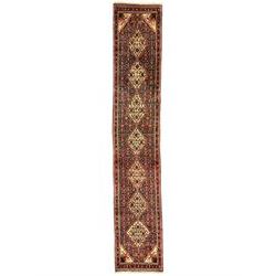 North West Persian pale indigo ground Senneh runner, the field decorated with seven linked medallions, decorated all over with Herati motifs, guarded border with trailing floral pattern