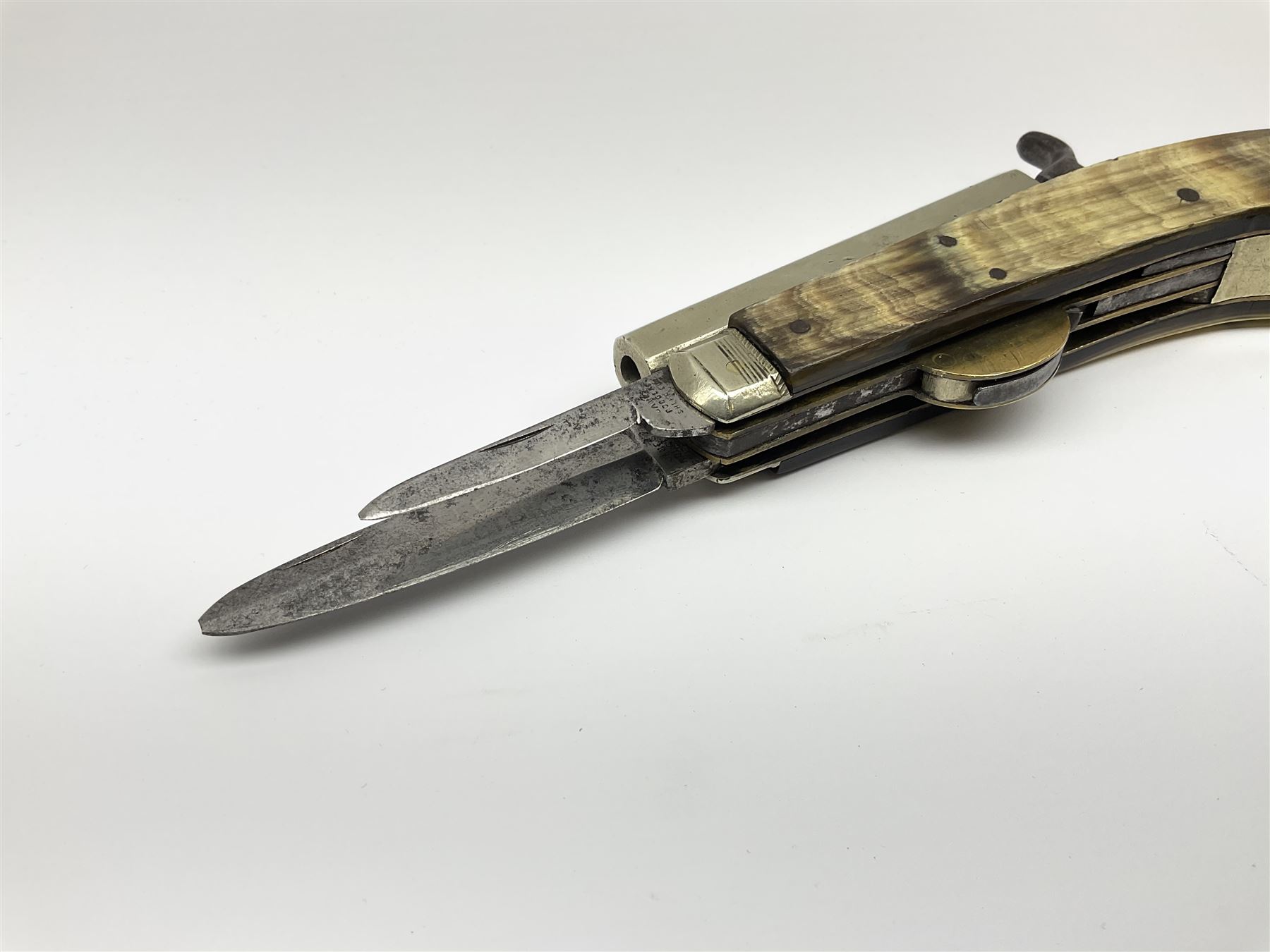 Mid-19th century James Rodgers Sheffield 160-bore (approx. 25cal.) percussion knife pistol with twin folding blades, known as 'Unwin & Rodgers Type', 9cm nickel tapering octagonal barrel with rear mounted nipple, boxlock central hammer action, smooth horn riveted side scales with nickel mounts housing nickel scissor action bullet mould, pair of tweezers and concealed butt compartment for ball/cap, folding trigger and two blades, one 8cm dagger style and one 5.5cm single edged utility blade L17.5cm overall closed
