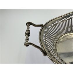 Early 20th century Dutch silver basket, of oval form with pierced sides, beaded rim, and twin handles, marked with Lion Passant for 2nd standard purity and date letter for 1910, other marks worn and indistinct, including handles H8.5cm L25.5cm